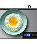 33 Pound Digital Kitchen Scale With Large 9 Inch Weighing Platform, Touch Control, LCD Display showing 388g with flour and eggs