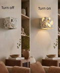 4.7" Mid Century Modern Wall Sconce, Minimalist Terrazzo Wall Light Fixture turned on, showcasing dappled light effects.