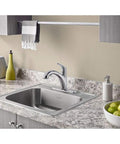 Colony Pro Pull Out Kitchen Faucet with Dope Sprayer and Ceramic Disc Valve installed in a granite countertop with chrome finish.