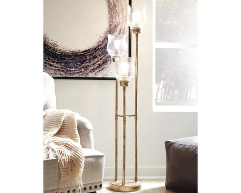 Emmie Traditional Floor Lamp With Adjustable Heights, Three Glass Shades, Antique Gold Finish, in a modern living room setting.