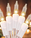 Close-up of 100 Count Clear White Wire UL Listed Connectable Warm White String Lights glowing with a festive background.