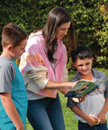 Adult and two children reading instructions for Extreme Geyser Tube Science Kit For Kids With Mentos And Soda Lab Experiment Includes Tube Candy And Unique Spray Caps To Create Turbo And Triple Cap Eruptions For Chemistry Magic In The Classroom STEM Project