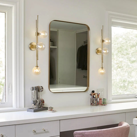 Chic Three Light Globe Glass Wall Sconces With Amber Glass Shades Mid Century Modern Indoor Wall Light Fixtures next to mirror