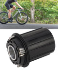 Cyclist in background with Beefy 11 Speed Bike Freehub Body For HG Flywheel, aluminum, 15mm axle, 4 claw design, in foreground