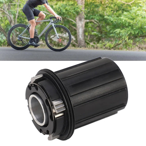 Cyclist in background with Beefy 11 Speed Bike Freehub Body For HG Flywheel, aluminum, 15mm axle, 4 claw design, in foreground