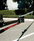 Ratcheting Off Road Utility Farm Jack 33 Inch for lifting and pulling, chains attached, positioned on asphalt