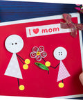 Handmade card with paper figures and 'I love mom' text using 500 Pieces Scrapbooking Paper Fasteners Brads Clip Set For Photos And Cards And Paper Crafts Durable Vintage Style Scrapbook Embellishments For Creative Journaling And Card Making