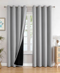 Total Blackout Bedroom Curtains With Thermal Liner, Light Gray 2 Panel Set, 52 By 95 Inches, Grommet Top, installed in room.