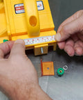 Close-up of hands measuring with a ruler on the GRR Ripper Safe Rip Upgrade Kit For Table Saw Safety. Orange cursor index visible.