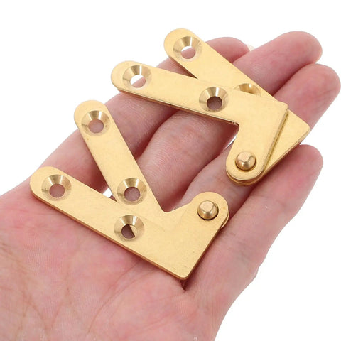 Brass Pivot Door Hinges Set Of 4 With Concealed Design in hand, showing gold finish and mounting holes for wood doors