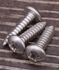 Heavy Duty Tough As Nails 304 Stainless Steel Pan Head Sheet Metal Screws Phillips Drive Self Tapping Rust Resistant Hardware For Wood And Metal Projects Pack Of Fifty close-up of three screws.