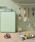 Heavy Duty Kitchen Scissors Set with 2.5mm stainless steel blades placed on a kitchen counter beside a salad and cutting boards.