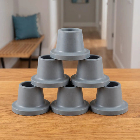 Stack of grey heavy duty rubber replacement feet for bath chairs and shower benches non slip grip 28.5mm hole universal fit