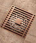 Solid Rose Gold Bathtub Stopper With Heavy Duty Brass Body And Reliable Anti Odor Seal For Showers And Floors built into a bathroom floor.
