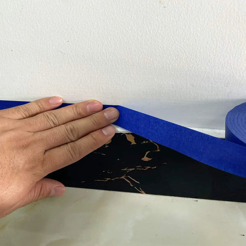 Applying Blue Multi-Surface Painter's Tape 0.94 In X 60 Yds along wall for clean edge