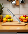 Pineapple Eye Remover Tool With V Shaped Stainless Steel Blade on kitchen counter with fruits, ergonomic handle kitchen gadget