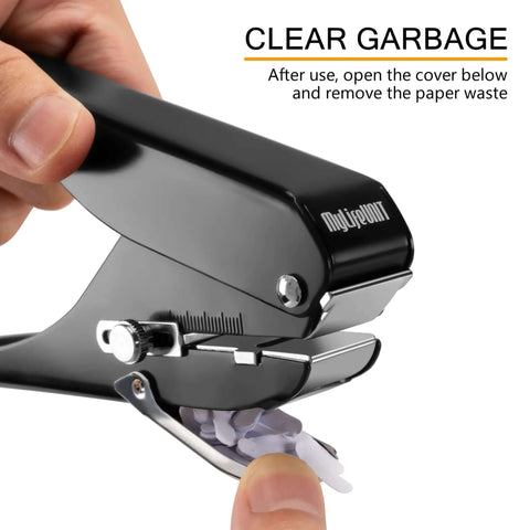 Close-up of badge hole punch slot puncher with open waste cover showing paper remnants