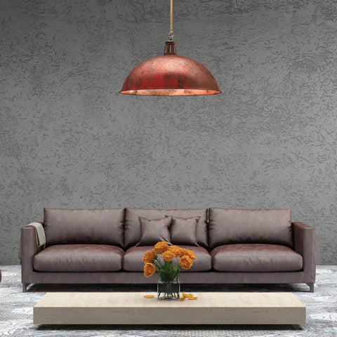 Living room with large brown sofa, industrial red pendant light, and low wooden table with orange flowers.
