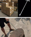 No Sweat Heavy Duty Stainless Steel T Hook Lifter For Manhole Covers Drain Grates Storm Sewers, 34 inch in use lifting a manhole cover.