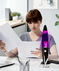 Person studies papers beside Purple Liquid Motion Lamp For Adults And Kids Magma Motion Lamp With White Wax Flows Glass Nightlight
