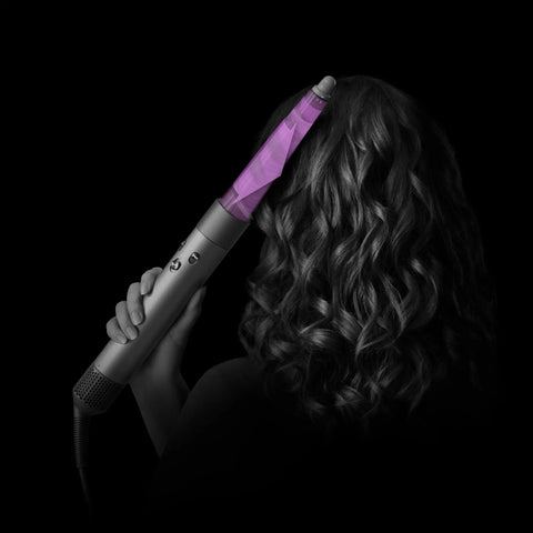 Woman using Conical Airwrap Barrel Attachment for defined curls and waves, dual direction styling, rotating cool tip