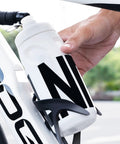 Leak Resistant Squeeze Lid Water Bottle For Biking And Hiking being placed in bike cage