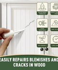 Person using White Touch Up Paint Pen For Wood Furniture Makeover Featuring Quick Dry Formula And Precision Brush on a cracked cabinet surface.