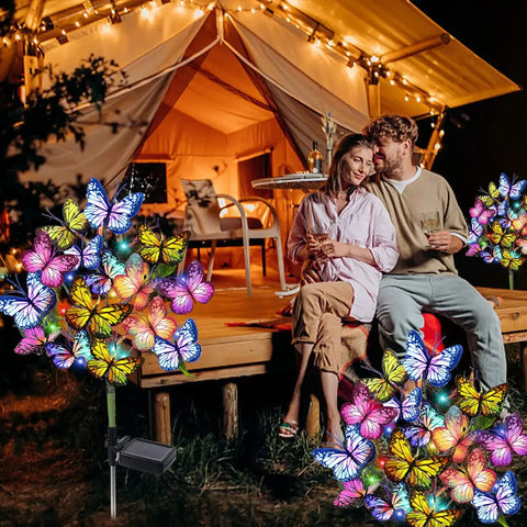 Solar Garden Lights Outdoor 2 Pack with 34 Butterflies and 44 LED Fairy Lights illuminating a couple near a tent at night