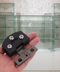 Heavy Duty Stainless Steel Glass Door Hinge For Tempered Glass Doors With Smooth Operation in a hand with glass cabinets background