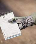 Nomex Flight Gloves 2.0 Sage Medium holding a notebook, showing upgraded fit and supple dexterity with leather reinforcement.