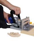 No Sweat Lightweight Electric Biscuit Jointer 760W in use, cutting slots in wood with biscuit pieces visible.