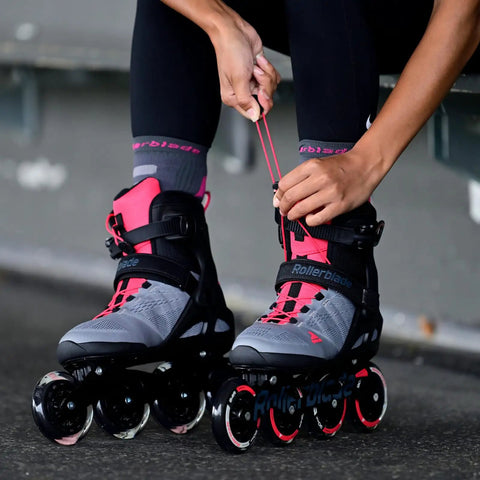 Woman tying Macroblade 90 W Inline Skates For Women With High Performance Fit, Enhanced Lateral Support, Stable Cuff in grey and pink