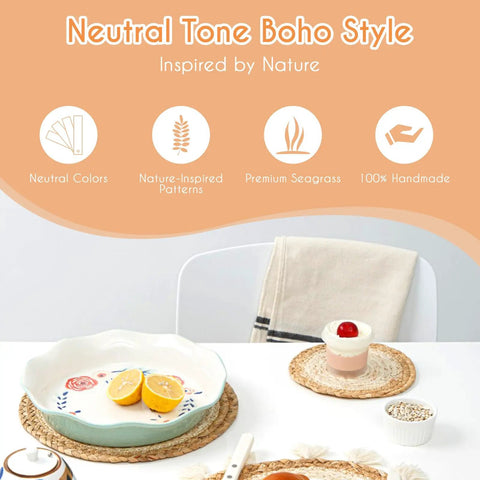 Neutral tone boho style kitchen items with seagrass placemats, a ceramic plate, and dessert bowl on a white table.