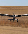RC Airplane Apprentice STOL S 700 BNF With AS3X SAFE Technology flying low over a grassy field