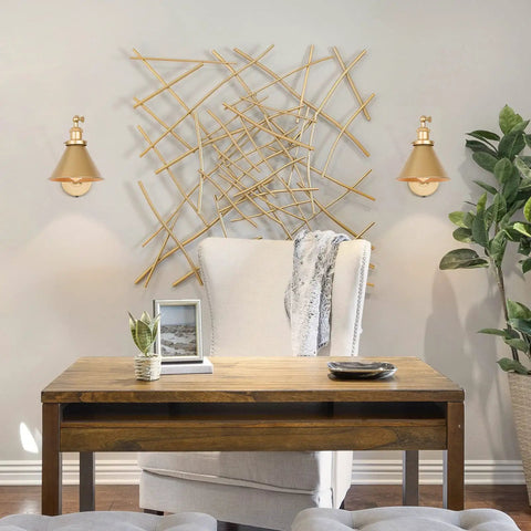Room with pair of gold brushed swing arm wall sconces with orange cord plug in or hardwired adjustable lighting fixture with inline switch