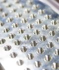 Close-up of metal showing threading holes for Spiral Point Plug Threading Tap M8 x 1.25 for Thread Repair application