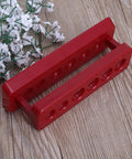 Red Six Hole Test Tube Holder Rack Portable Plastic Stand For Lab Burette Shelf on wooden surface, student lab gear