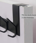 Close-up of Over The Door Hooks Towel Rack With 6 Hooks, black, showing sturdy bracket on white door.