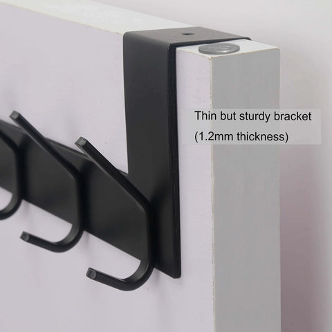 Close-up of Over The Door Hooks Towel Rack With 6 Hooks, black, showing sturdy bracket on white door.