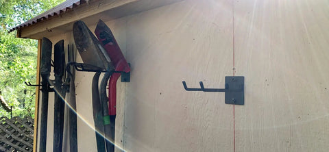 Heavy Duty Steel Wall Mount Tool Organizer for Garage Storage and Garden Tools Shovel Holder Rake and Broom Hooks installed on shed