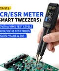 Person using LCR ST1 10KHz LCR Meter With Tweezers Beast All In One SMD Tester ESR Meter Multimeter on a circuit board