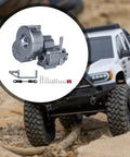 Aluminum Alloy RC Transmission Gearbox Kit for 1:10 Scale Crawlers with mounting hardware on a rugged terrain background