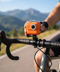 Cyclist holding 4K Magnetic Action Camera With 48MP Sensor Dual Battery System 2.0 Inch Flip Touch Screen EIS Stabilization on handlebar
