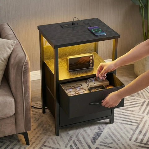 LED Nightstand With Charging Station, USB Ports And Outlets, Dope RGB Color Changing LED Night Light, Built In Storage Drawers, Modern Black Finish in use next to sofa.