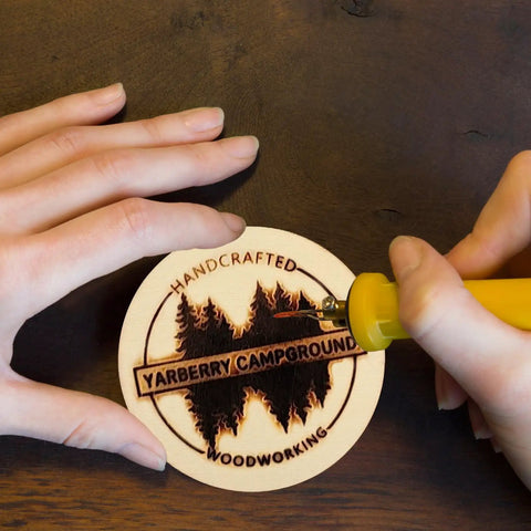 Person engraving a design onto a Sweet Unfinished Wood Circles For No Sweat Diy Crafting With Pack Of Thirty Six Three Inch Wooden Rounds.