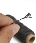 Close-up of hand holding black waxed leather thread spool, part of Waxed Leather Sewing Thread Kit With 55 Yard Spools And Pro Grade Needles, DIY Weave Repair For Upholstery, Car Interiors, Bags, Leather Craft, Canvas And Home Projects, 8Pcs Black.