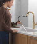 Modern Brushed Gold Kitchen Faucet With Pull Down Sprayer And Single Handle Slick Champagne Bronze Finish Smooth Glide Cartridge No Fuss Single Hole Setup in use.