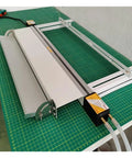 125Cm Acrylic Bender Heater Nailing Precise Temperature Control With Smart Water Cooling For Zero Hassle Plastic Sheet Bending on a green cutting mat.