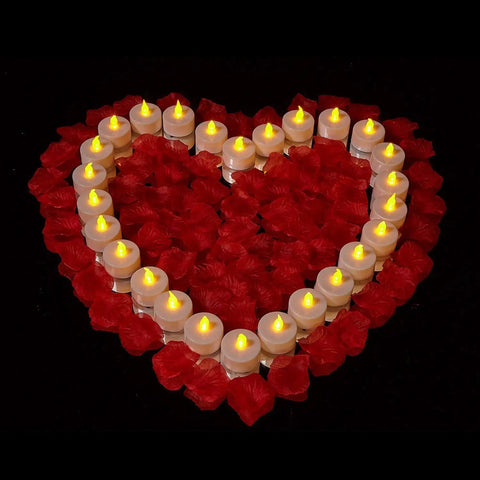 Heart-shaped arrangement of 100 pack flameless LED tea light candles for parties and home decor, warm yellow flicker glow