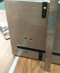 Close-up of the 8 Inch Precision Tilting Rotary Table showing metal housing, ruler for measurement, and tool accessories.
